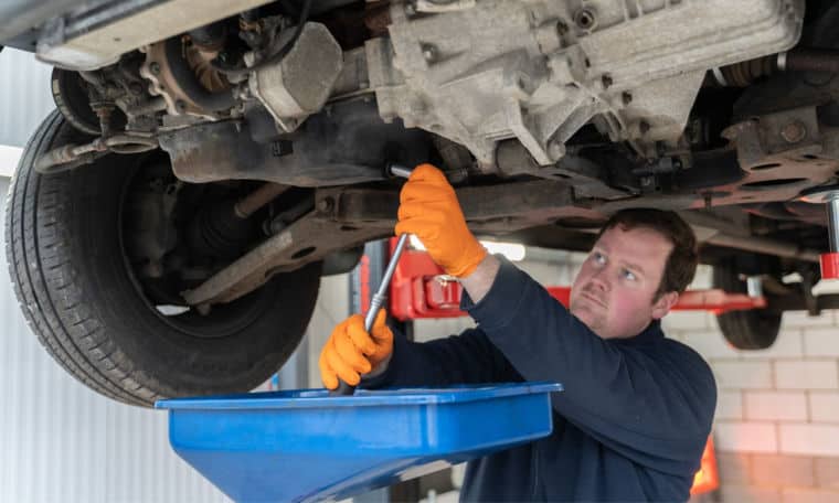 Service team inspecting the suspension on a motorhome.