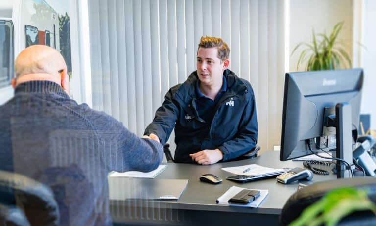 Webbs Caravans Sales staff assisting customer with sale of a second-hand caravan.