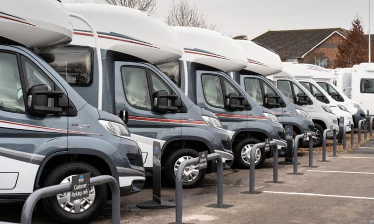 An array of used Motorhomes for sale lined up in the Webbs Motor Caravans' forecourt in Reading.