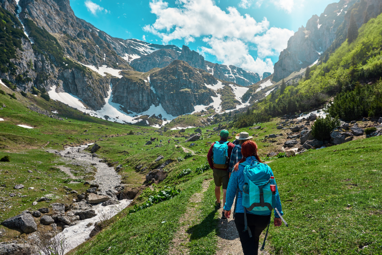 Some hikers walking towards a snowy mountain range. A Webbs blog on ensuring safety and security in your motorhome or caravan adventure.