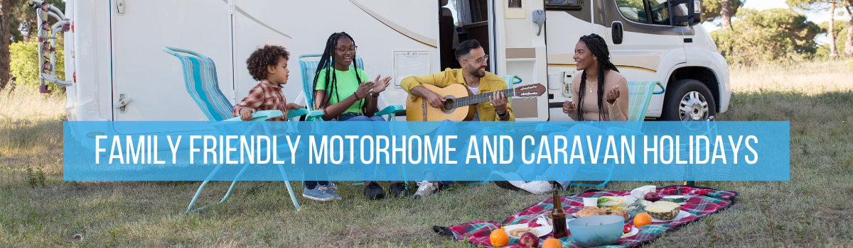 A family sat with a picnic, enjoying a motorhome holiday together. Family Friendly Motorhome and Caravan Holiday Ideas by Webbs.