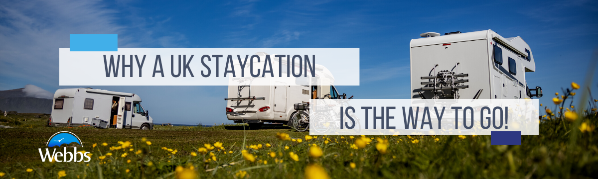 Motorhomes in a field full of flowers with blue skies. Why a UK Staycation is the Way to Go by Webbs.