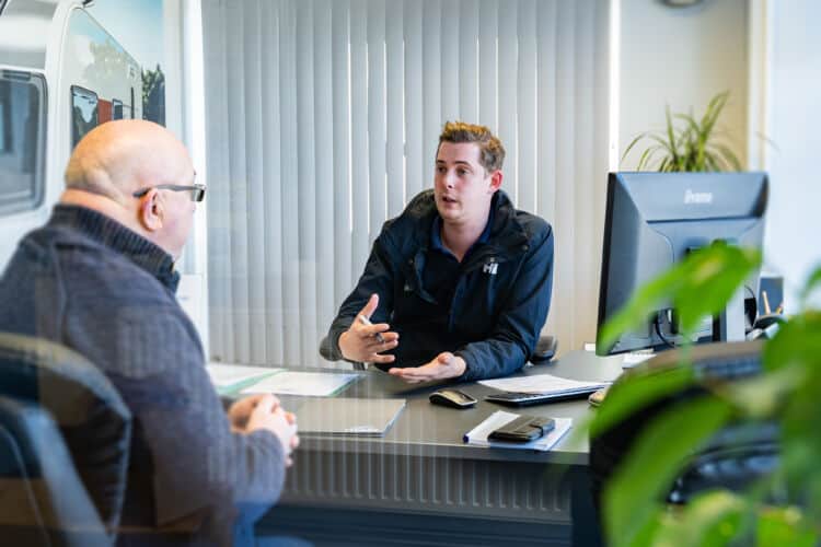 A Webbs Caravans sales person advising a customer. The Year Of The Caravan by Webbs.