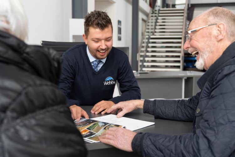 Staff assisting customer in Webbs Motor Caravans' accessory shop.