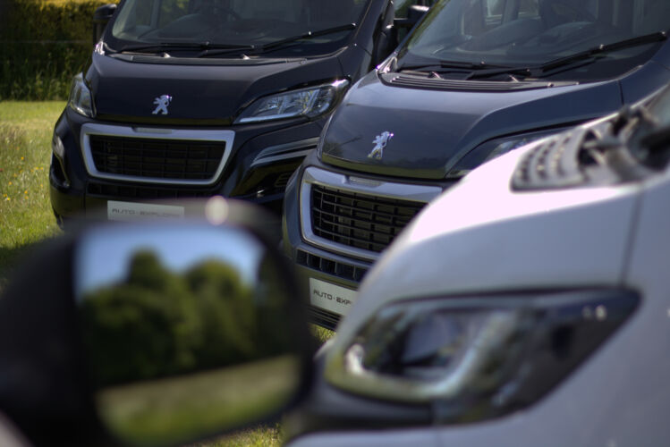 The front of three Auto-Explore van conversions lined up next to eachother.