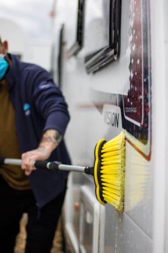 A Webbs employee washing one of the caravans that are stocked at the showroom