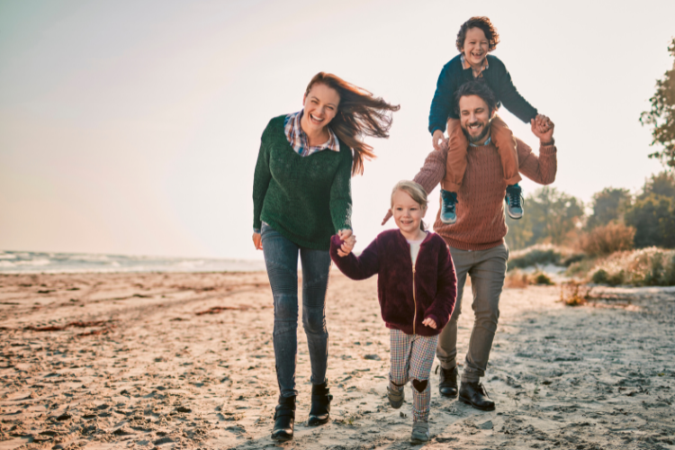 A family enjoying the beach in Cornwall. Touring Routes to Explore in the UK by Webbs.