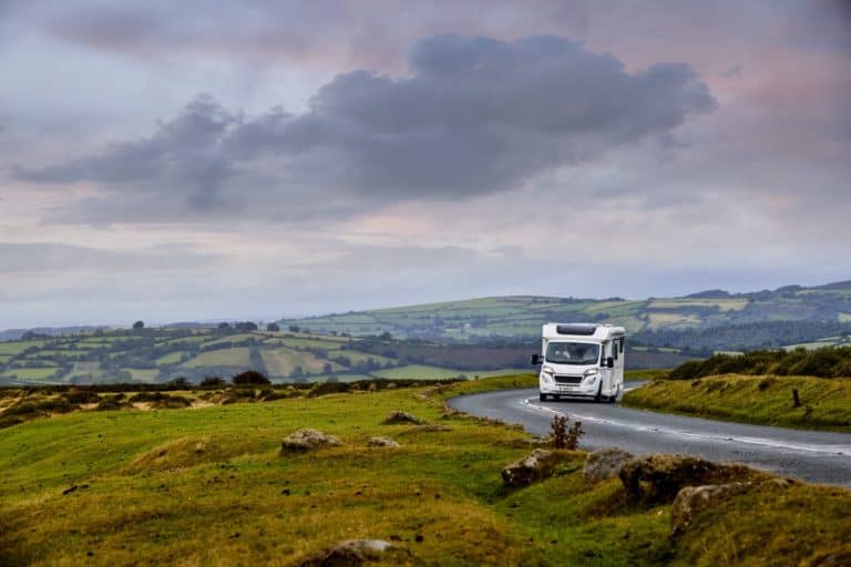 A motorhome approaching on an open road. Used & new motor homes for sale at Webbs Motor Caravans, Reading, UK.